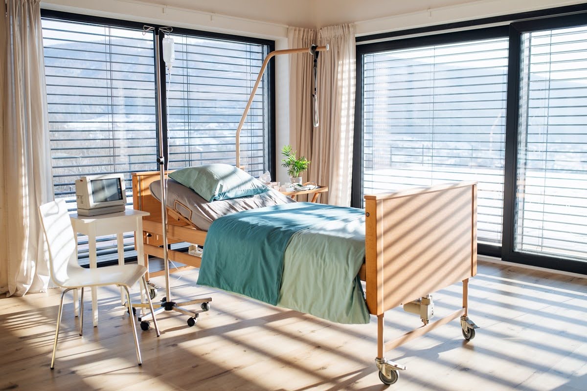 An empty, adjustable bed in room in private modern hospital.